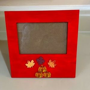 Rustic picture frame decorated with pumpkins and leaves